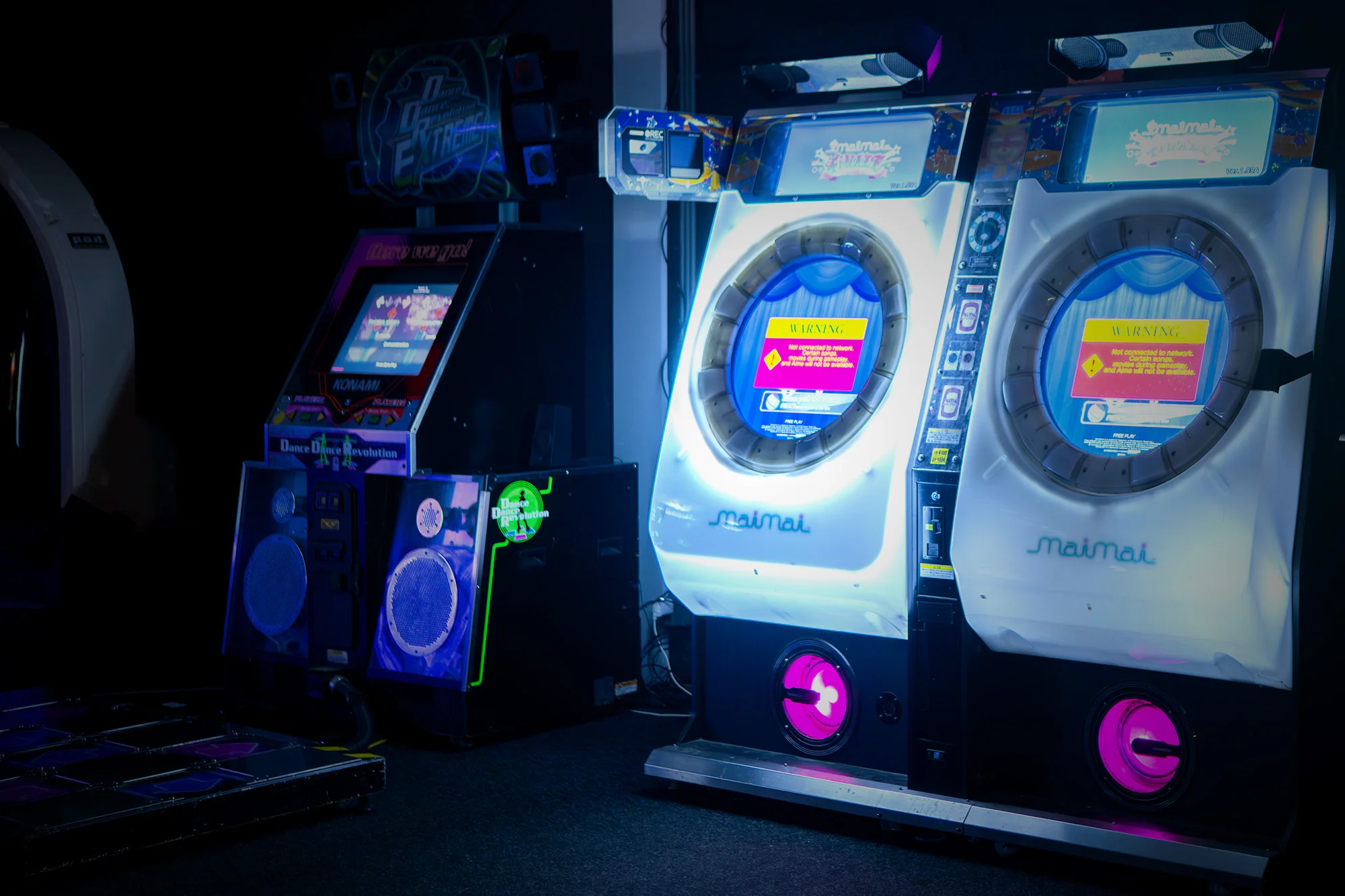 Two circular-screen rhythm game machines at Blast Galaxy